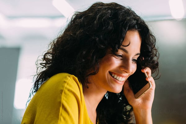Woman in yellow shirt talking on cellphone Woman in yellow shirt talking on cellphone
